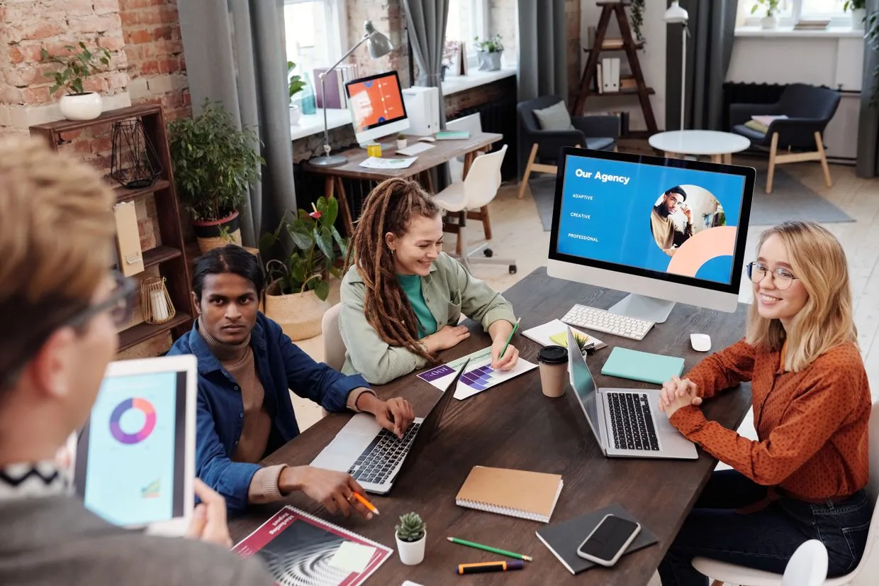 Web Design — A design and branding team reviewing work together in a studio