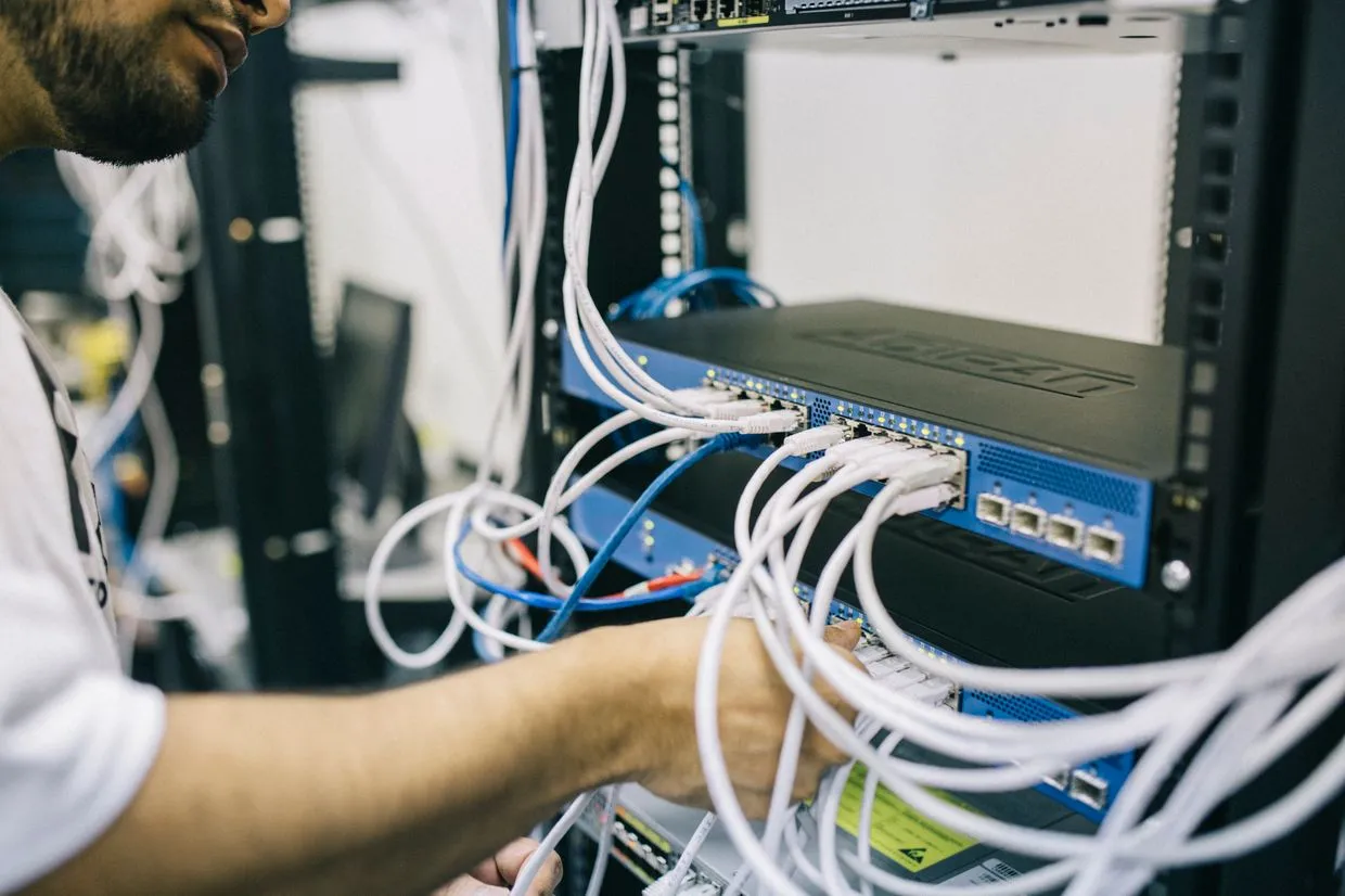 Website Maintenance — An engineer maintaining servers and network hardware