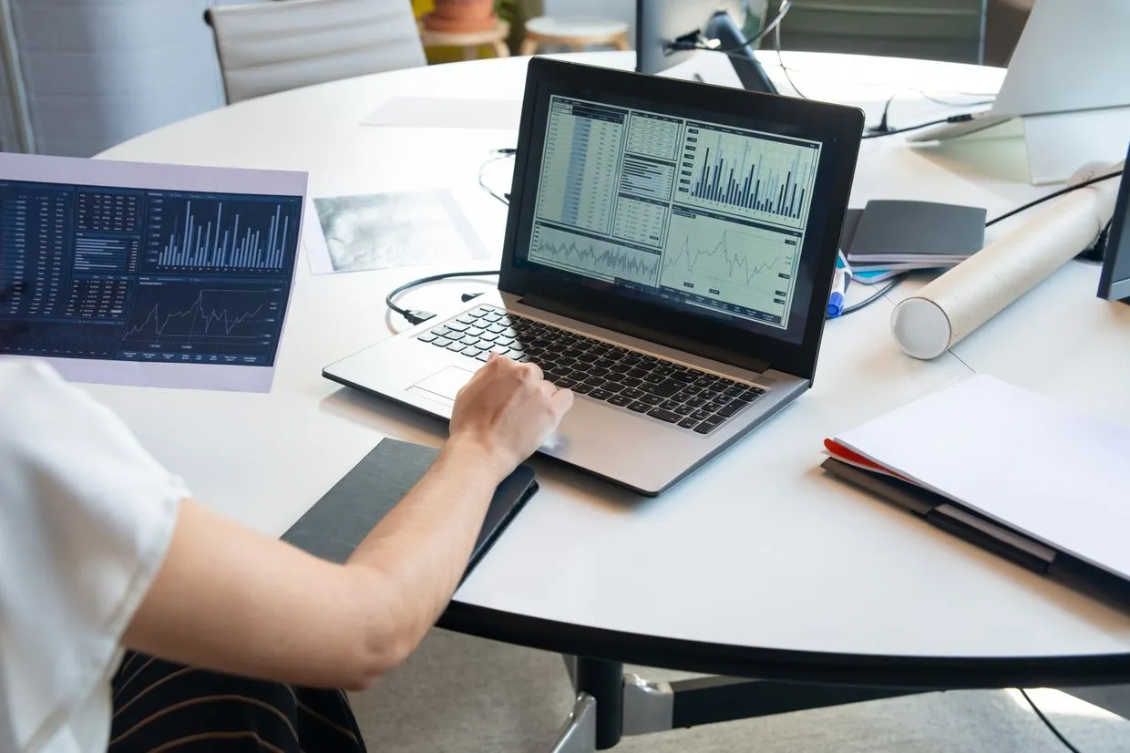 SEO Services — Marketing analyst reviewing search traffic and rankings on a laptop