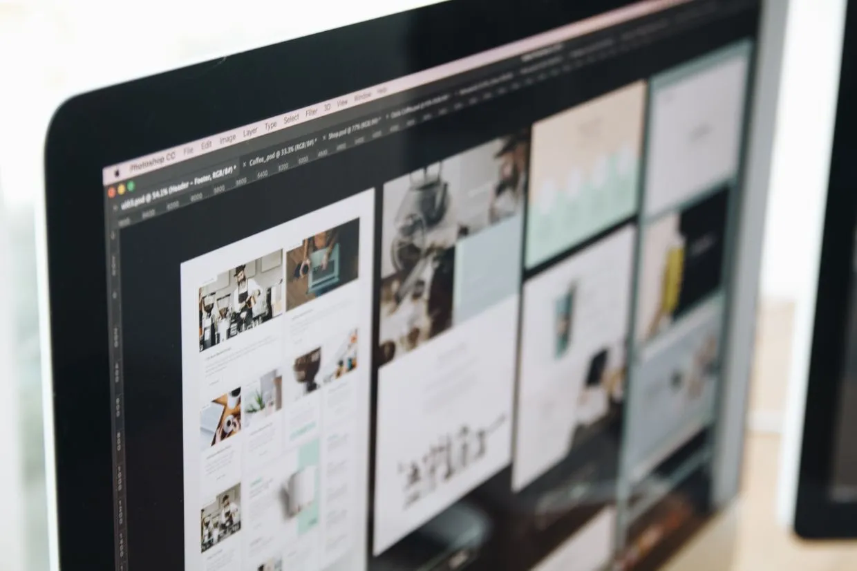 CMS Development — Website page designs laid out on a designer's screen